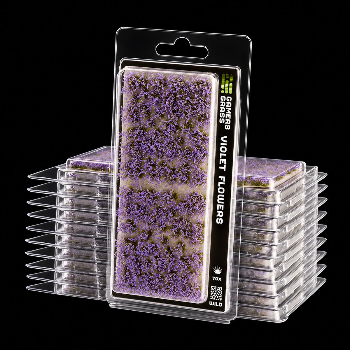 Blíster Violet Flowers de Gamer’s Grass con pequeñas flores violetas y envases apilados detrás.