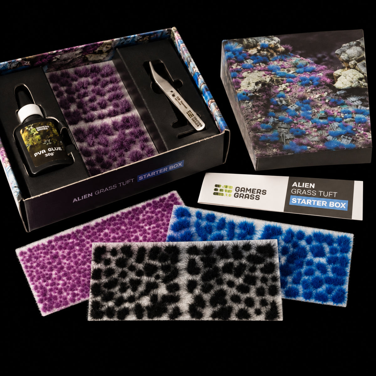 Alien Grass Tuft Starter Box de Gamer’s Grass abierto, con bandeja interior, pegamento, matas de colores y folleto.